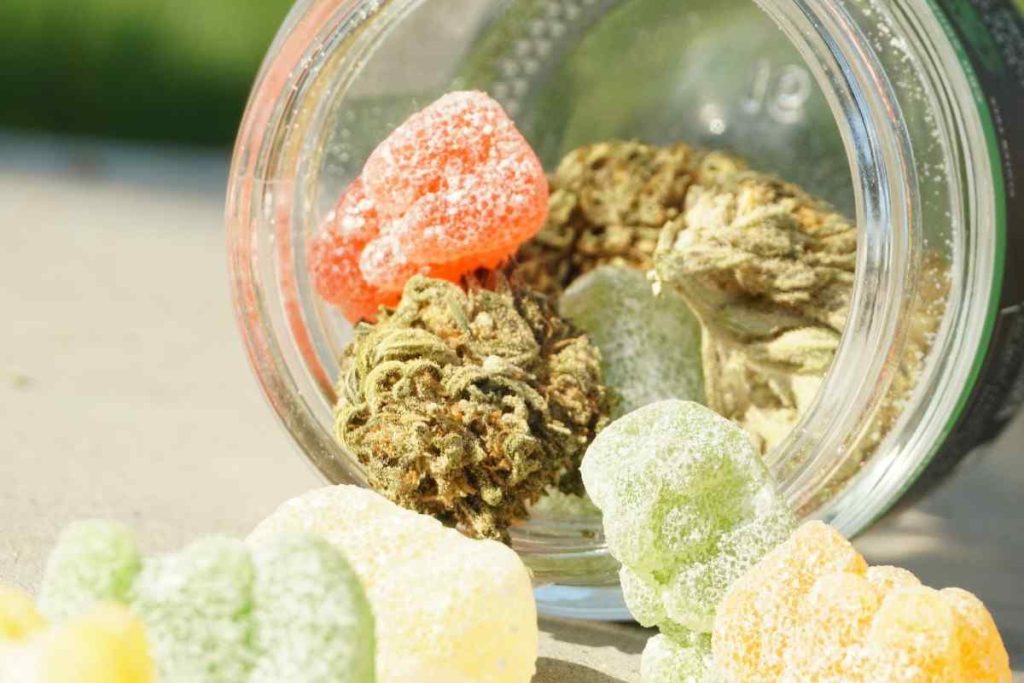 cannabis and chewy candies in a glass container