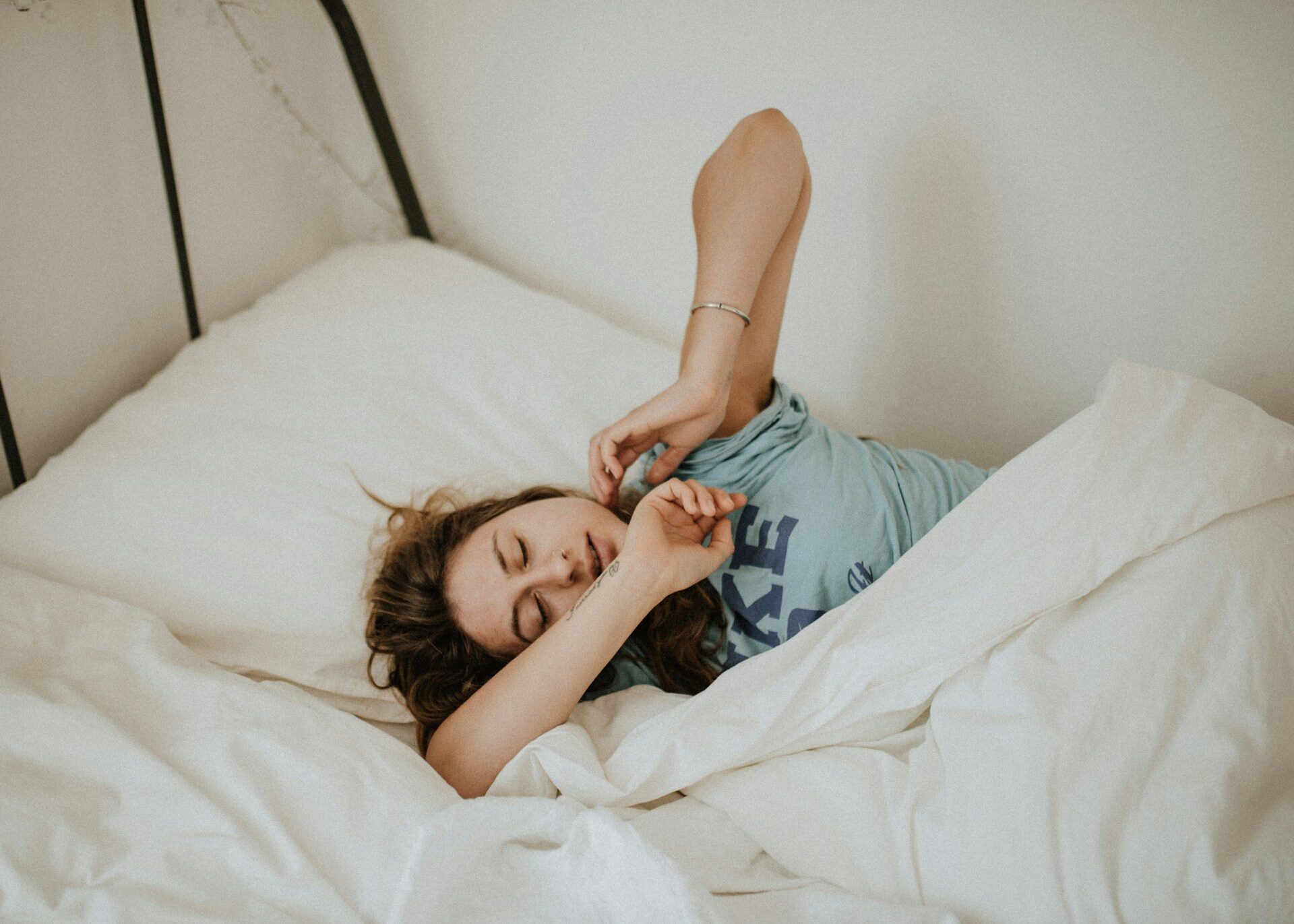 woman under a blanket in bed