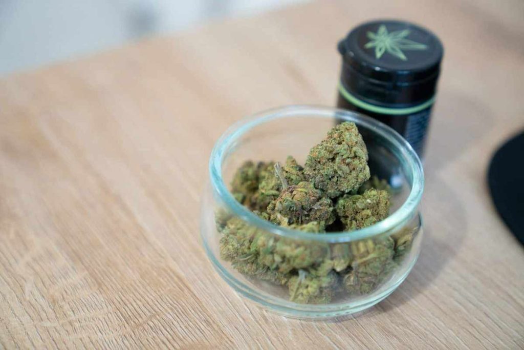 glass jar marijuana wooden table